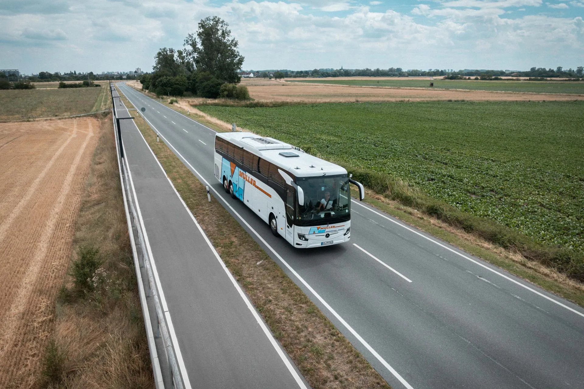 Müller-Reisebus unterwegs durch die Felder des hessischen Rieds