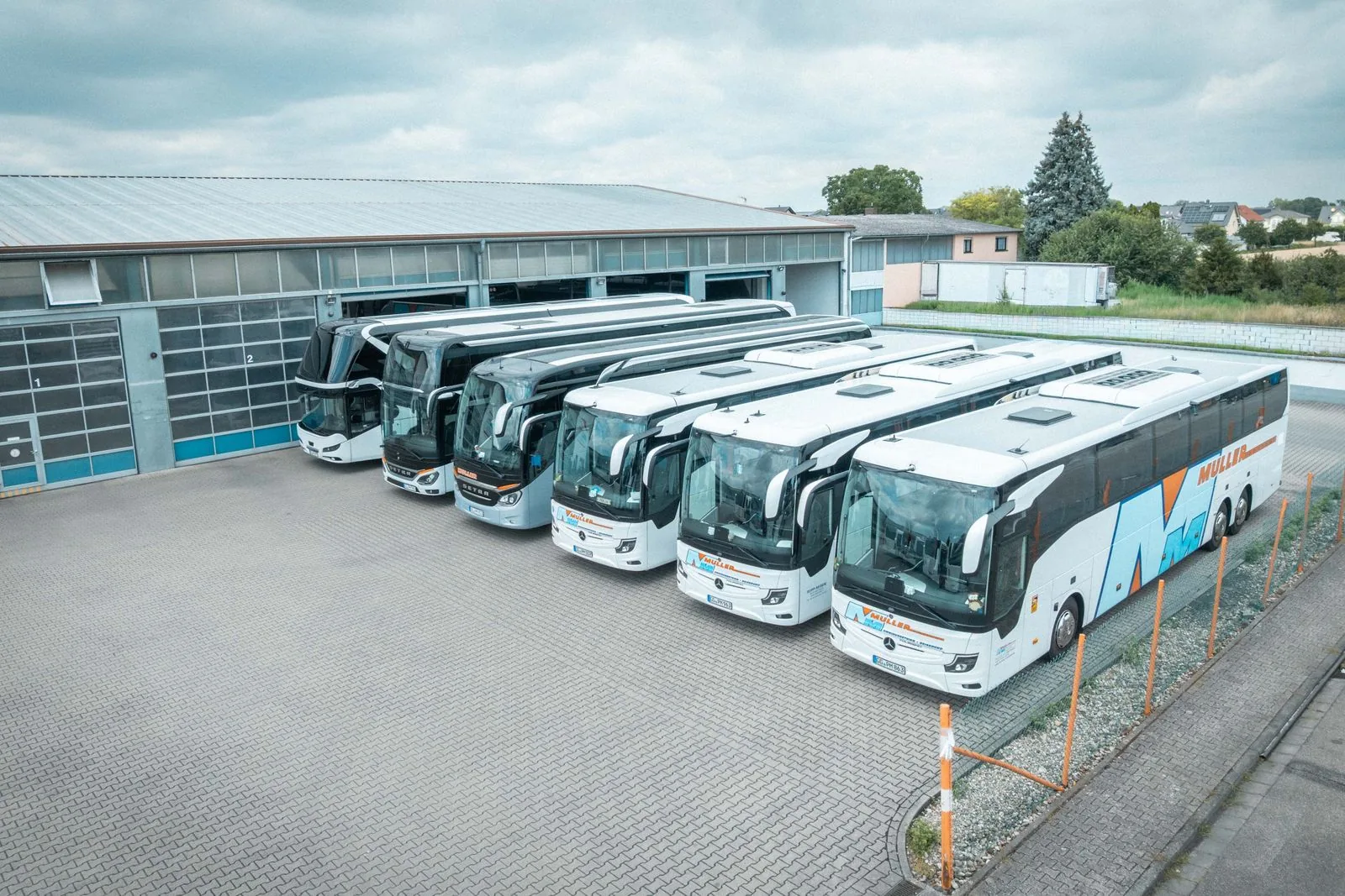 Die Reisebus-Flotte von MÜLLER Riedstadt vor der Halle